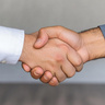 Two men's hands held in a handshake